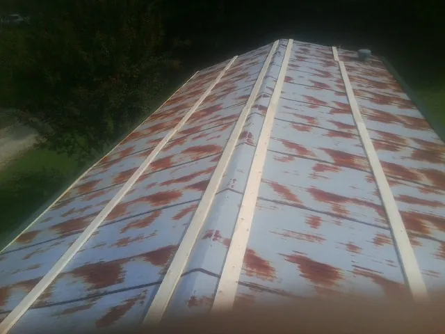 Rusted metal roof panels with new wood purlins before replacement — Storm Damage Roof Repair in Mexico by Roofing Brothers
