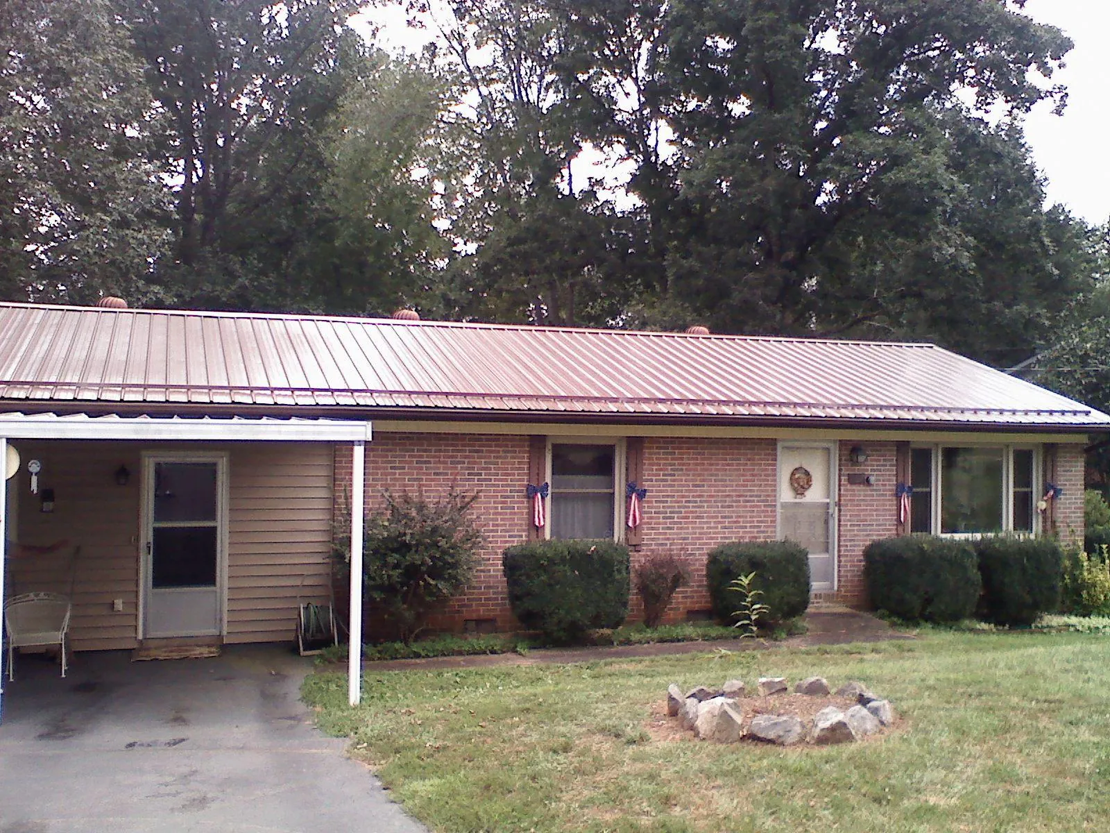Bronze metal roof and carport on a brick ranch home — Roof Repair work by our crew in Mexico