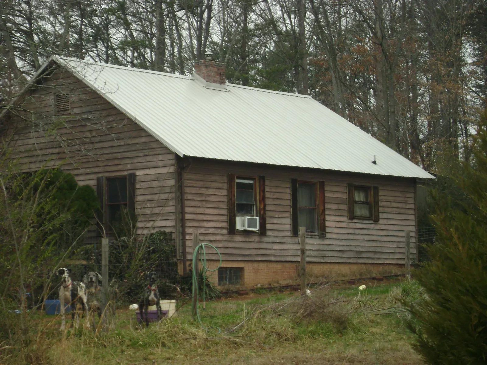 White metal roof on an old wood sided farmhouse, from a Metal Roof Installation job in Mexico